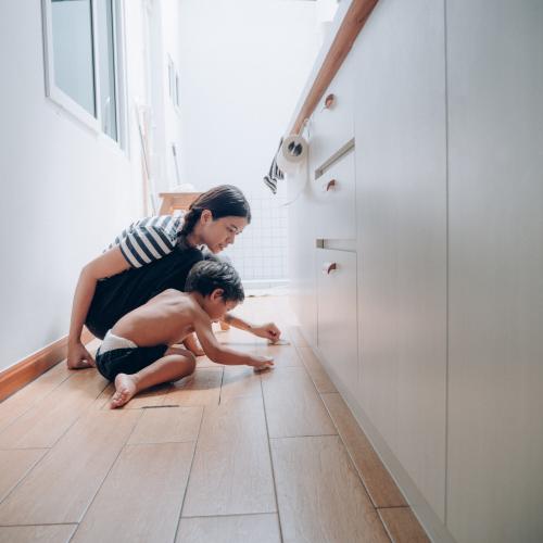 Mother and child on kitchen floor