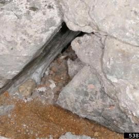 Hole in foundation showing rodent entry point