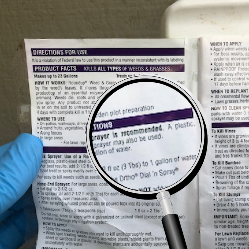 Gloved hands holding fungicide package to read label