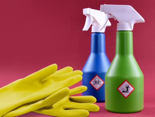 Pesticide spray bottles and gloves