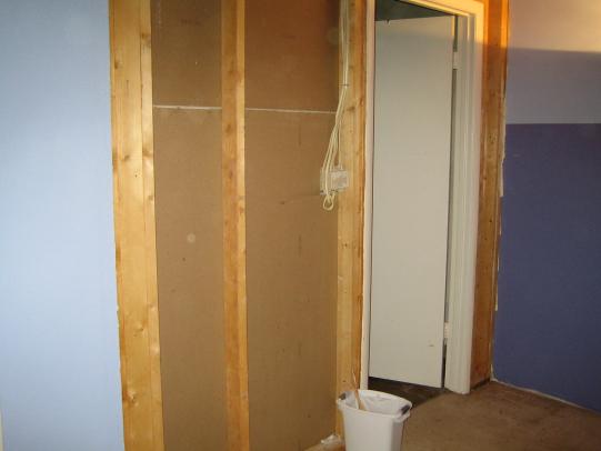 Drywall removed to wooden wall framing
