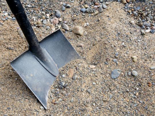 Shovel in sandy soil
